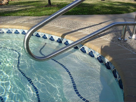 Taking care of your pool plaster surface - Steps with blue tiles